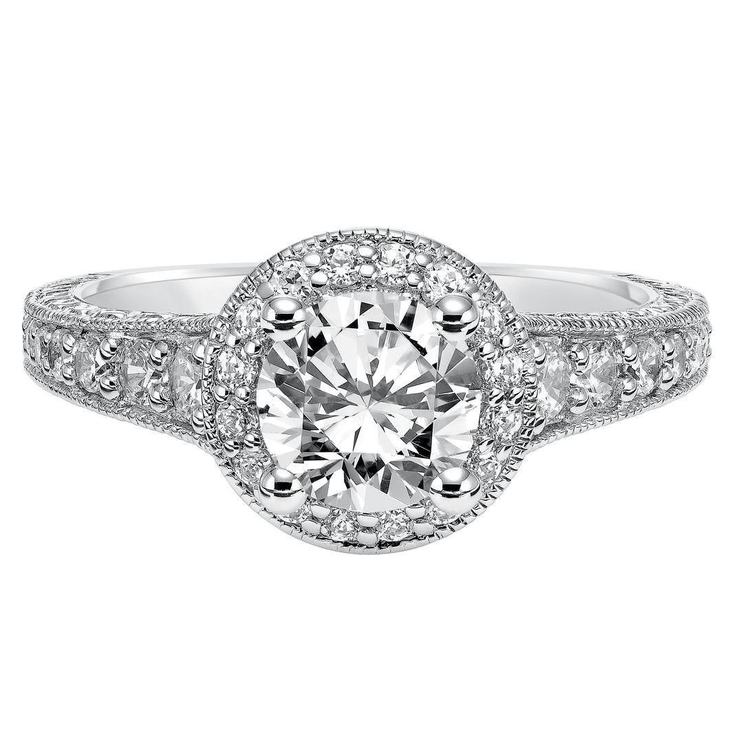 This show-stopping engagement ring is sure to impress with its diamond prong set halo and band with milgrain and engraving.  Center Stone is not included.