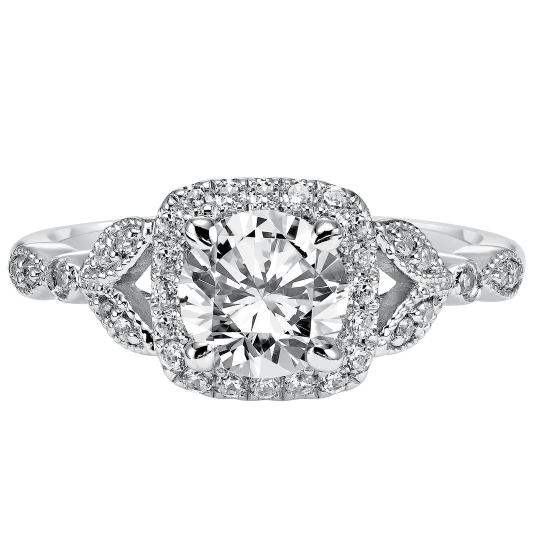 This whimsically styled engagement ring sparkles with its filigree and diamond halo and diamond prong set floral-inspired band.  Center Stone is not included.