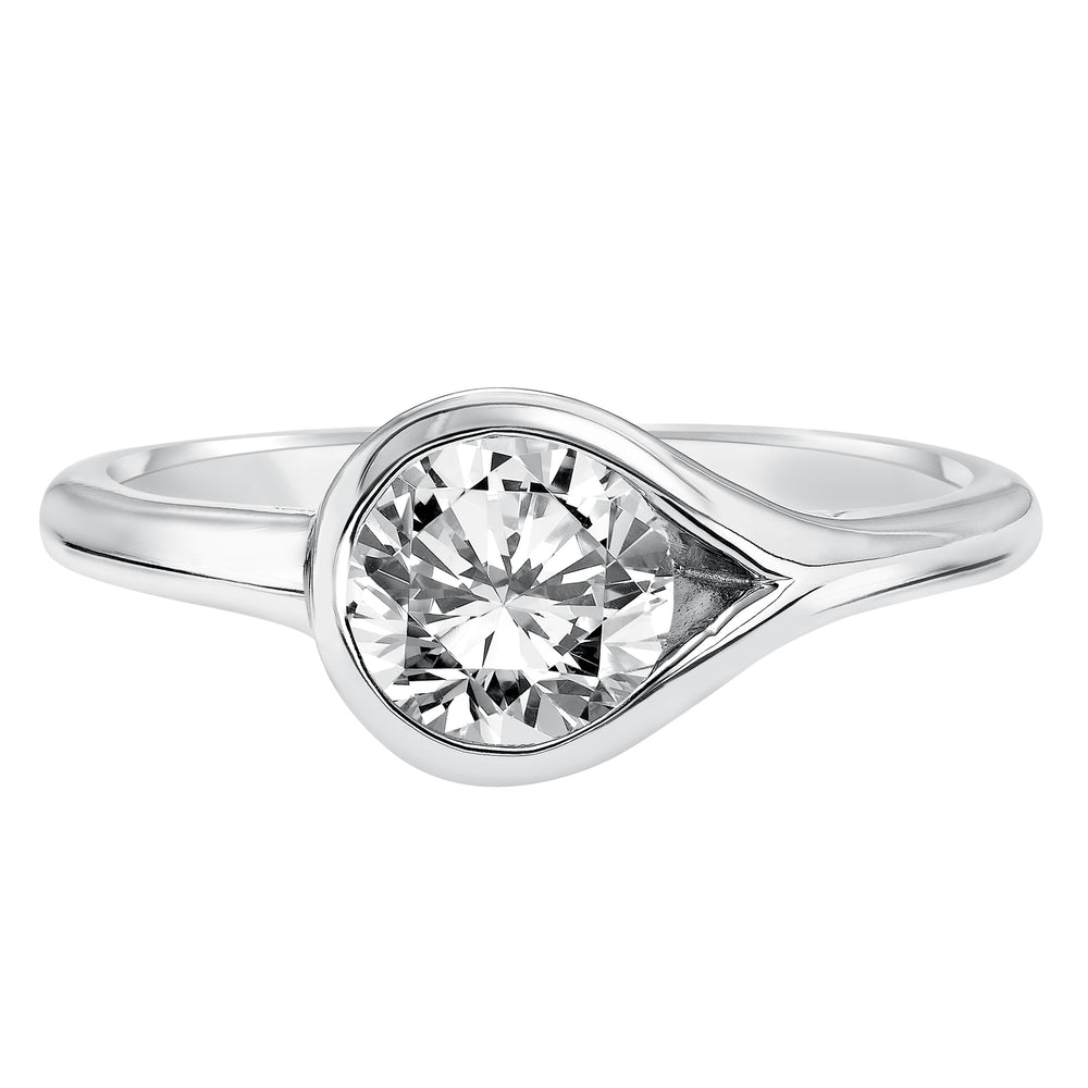 Chic and modern, this engagement ring is set beautifully in a high polished bezel set and bypass designed band