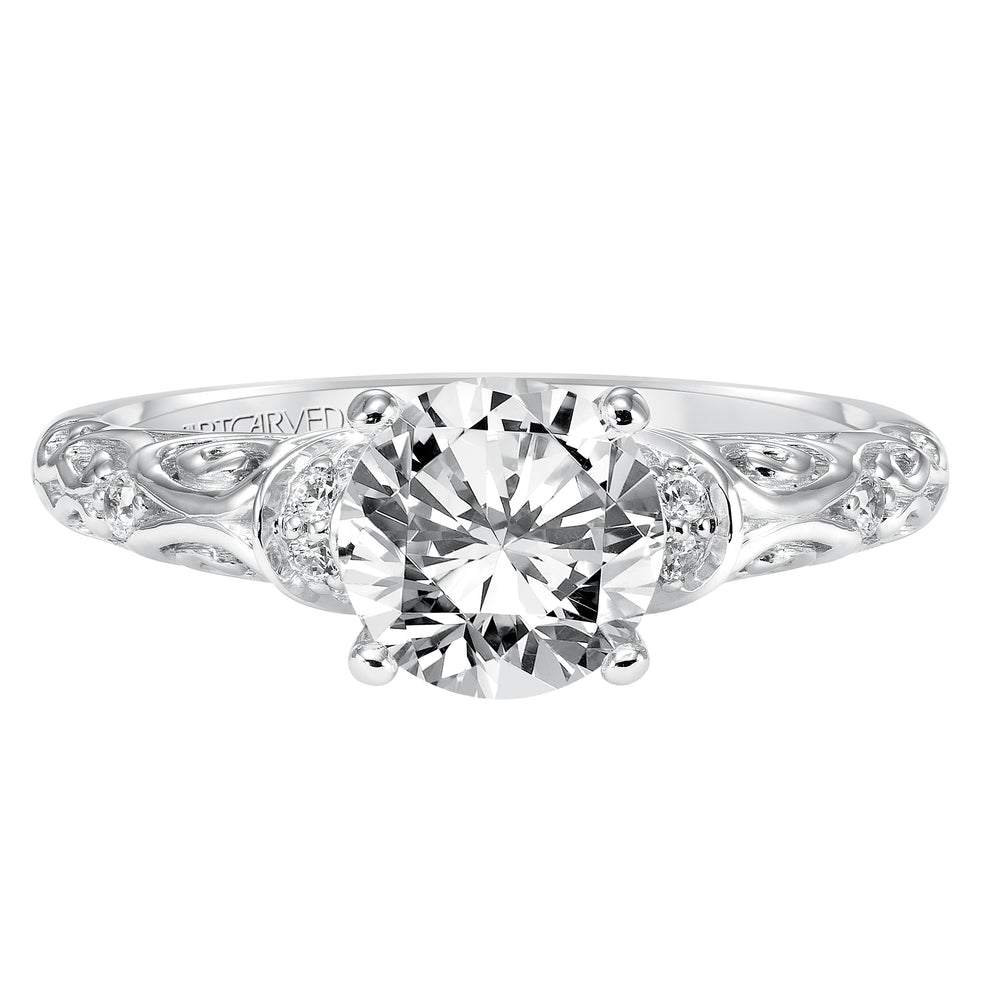 Diamond engagement ring with round center stone and carved diamond enhanced band